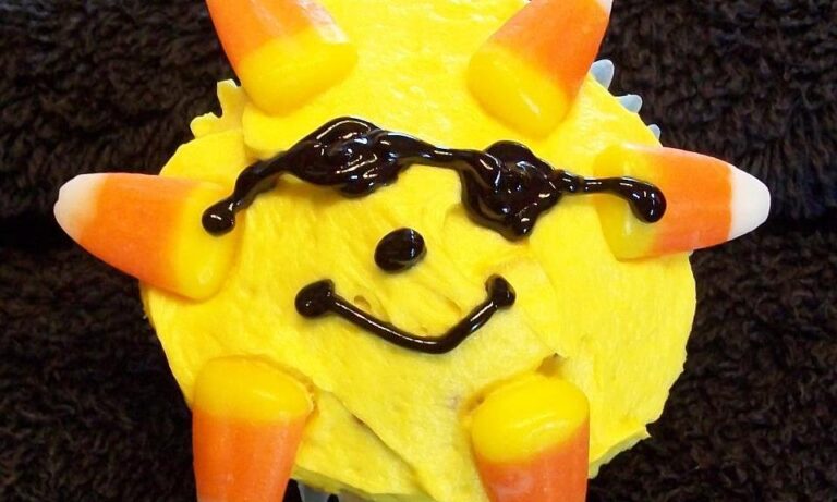 Smiling yellow Pikachu figurine with orange ears and black curved eyebrows