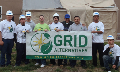 Team holding GRID Alternatives banner at community volunteer event