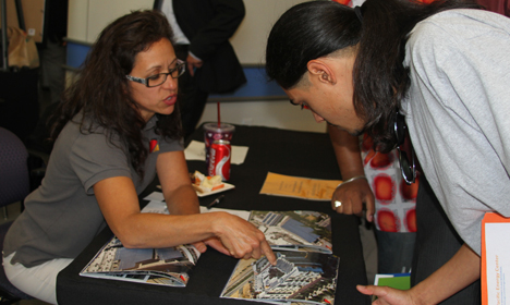 Two people examining comic books at a GRID and PG&E job connections event