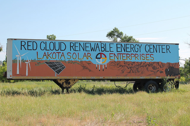Red Cloud Renewable Energy Center billboard with solar panel graphics in grassland