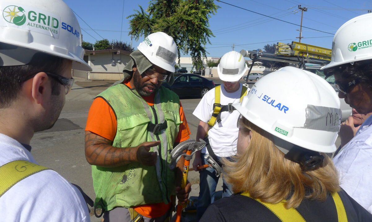 Grid Solar team leaders demonstrate safety equipment during outdoor training session