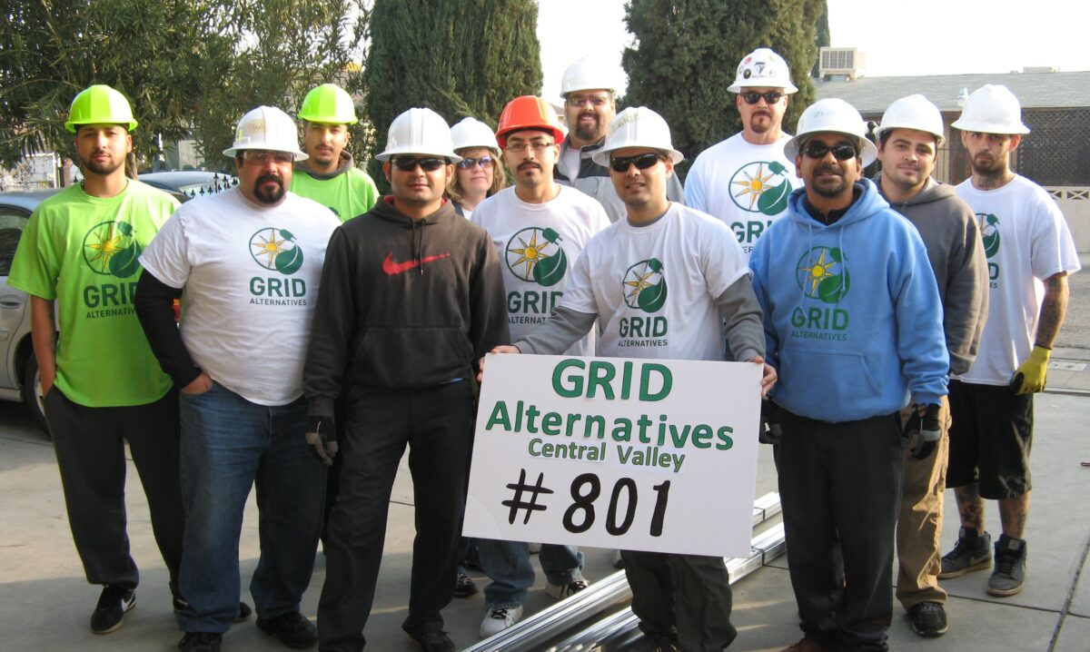 GRID Alternatives Central Valley team of workers holding sign celebrating #801 installs milestone