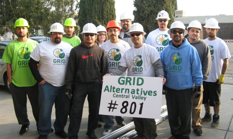 GRID Alternatives Central Valley team of workers holding sign celebrating #801 installs milestone