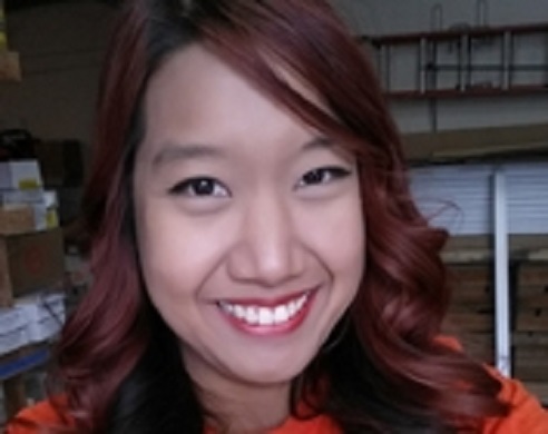 Vichuda Fuentes smiling in an indoor setting wearing a red top