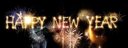 Happy New Year text with colorful fireworks bursting against a black night sky
