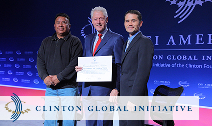 Three men holding a certificate at Clinton Global Initiative event for tribal solar initiative