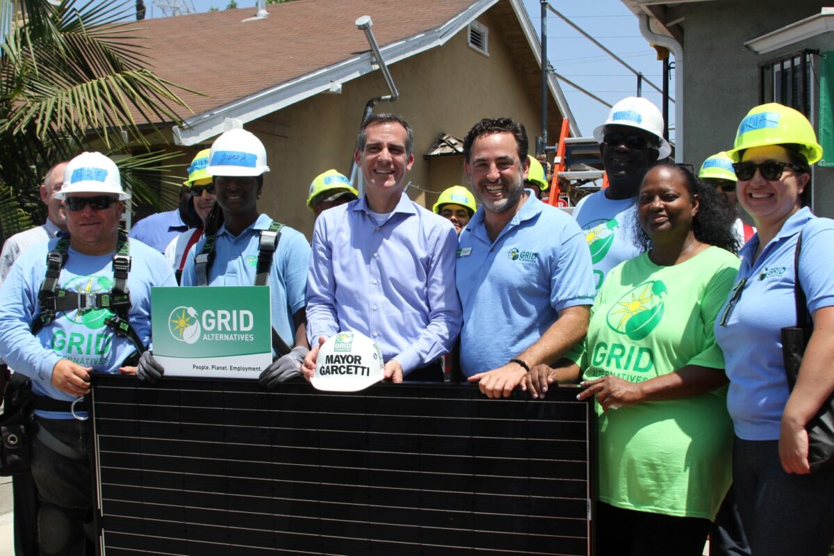 Mayor Garcetti and GRID Alternatives team members holding solar panel at LA 500 pledge event