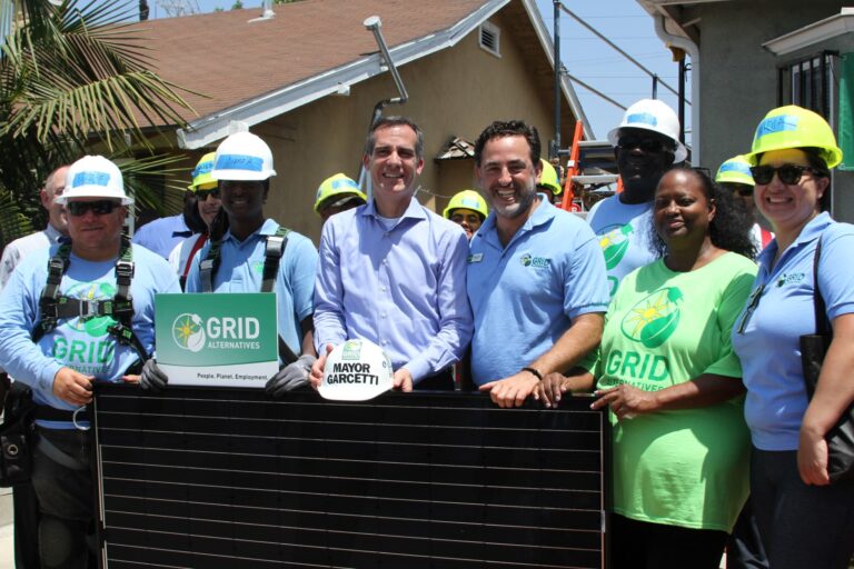 Mayor Garcetti and GRID Alternatives team members holding solar panel at LA 500 pledge event