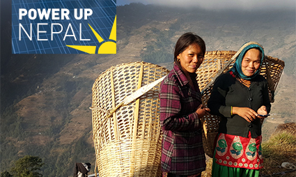 Two Nepali people holding solar panels with mountains in background, Power Up Nepal logo visible