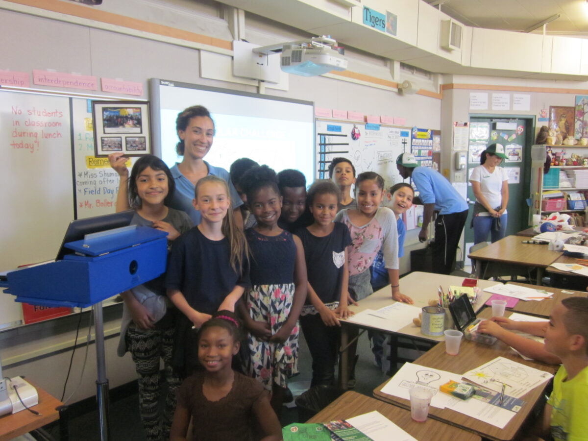 Group of fourth graders with female instructor in classroom during Solar Futures workshop at Northwood Elementary