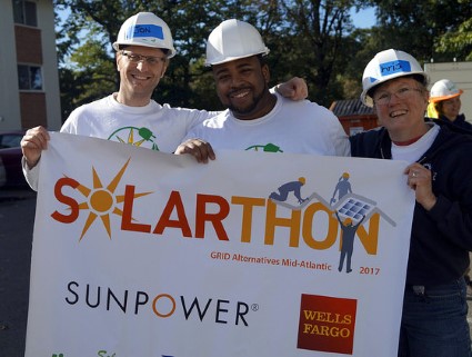 Three Solarthon volunteers take a break from installing solar