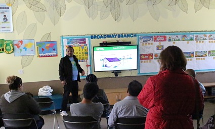 Classroom presentation with instructor displaying airplane diagram on screen to seated students