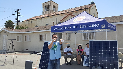 Councilman Joe Buscaino at solar panel display booth during Earth Day community event