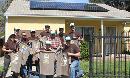 People in front of newly installed solar system