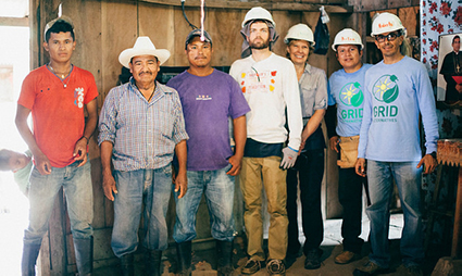 People in hard hats smile on construction site in Nicaragua