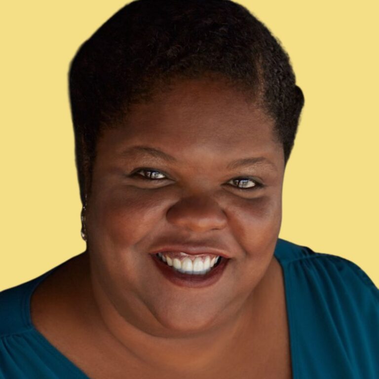 Melicia Charles, smiling woman wearing a teal blue shirt against a yellow background