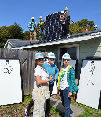 The Camp Solar group passes panels to the roof