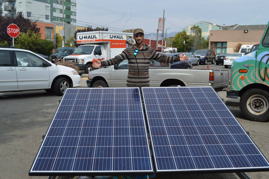 GRID system designer, Matt Kroll, shows off the solar generator he built for the Creating Commons music stage