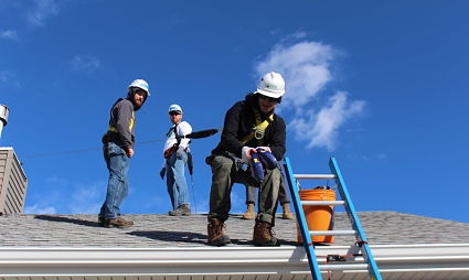 Three solar installers on the roof