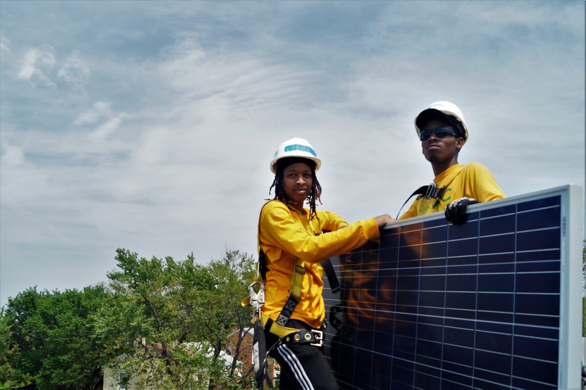 Two Solar Works DC trainees take a quick break during an installation in Washington DC.