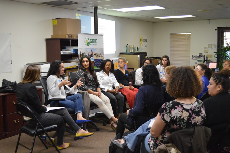 Group of women sitting in circle for discussion at GRID office event