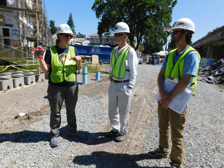 Erica Mackie, GRID Alternatives Co-Founder stands next to Board President Buzz Blacket accompanied by GRID Alternatives Bay Area's System Designer/Project Manager Matthew Kroll