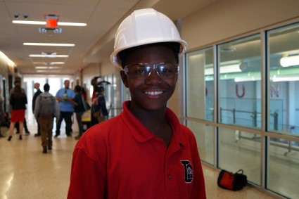 A Dunbar student takes a break from installing and poses for the camera