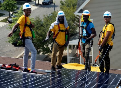 GZEP/SWDC job trainees stand by a completed solar system