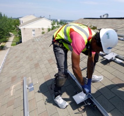 GZEP participant working on a roof
