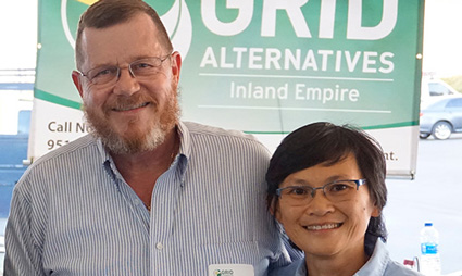Two people smiling at Inland Empire Grid Alternatives event