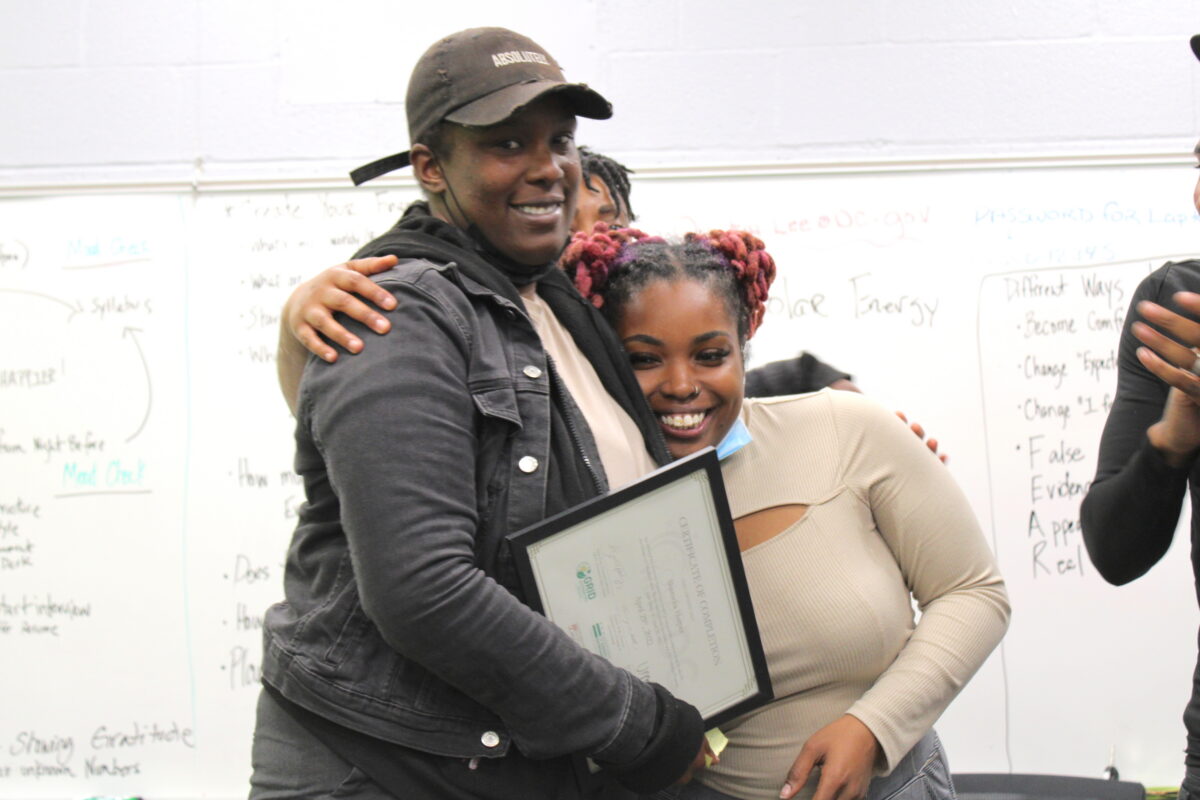 Solar Works DC trainee Shameka (left) celebrates graduating the program with GRID Mid-Atlantic workforce supervisor Dominique.