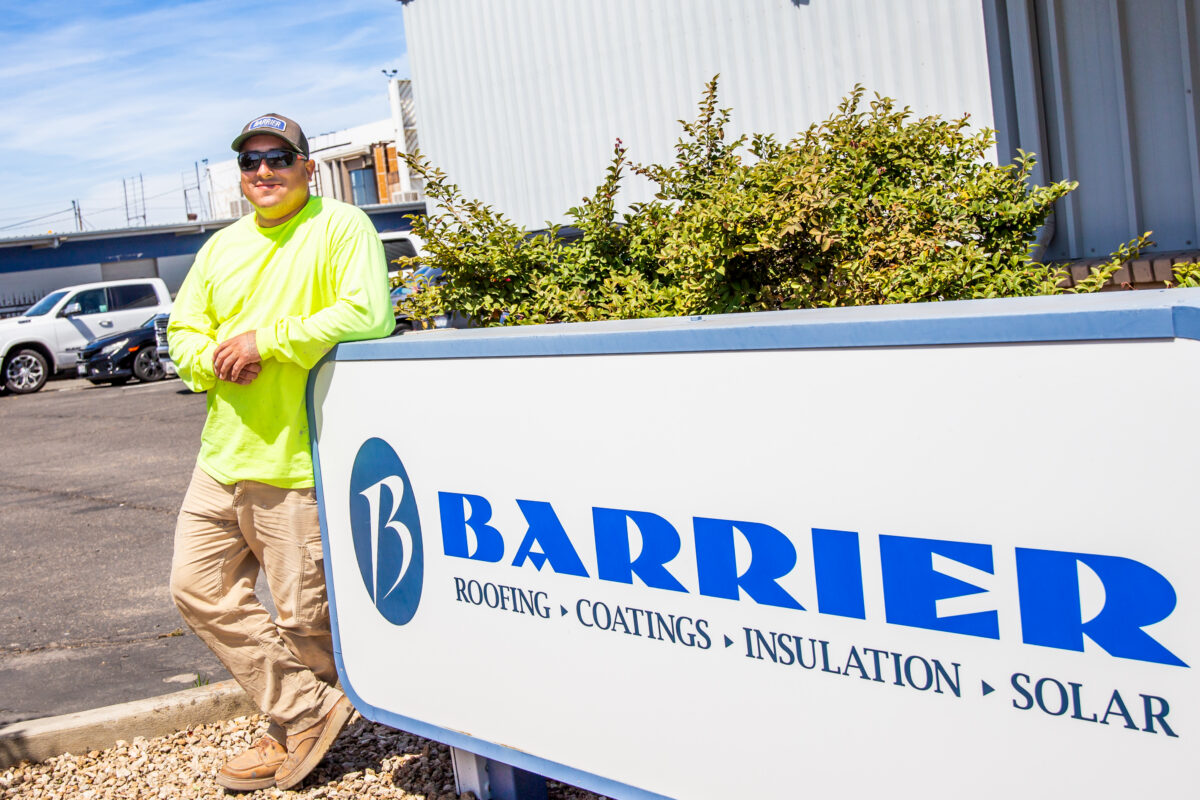 Jacob standing in front of a employer sign that says "Barrier"