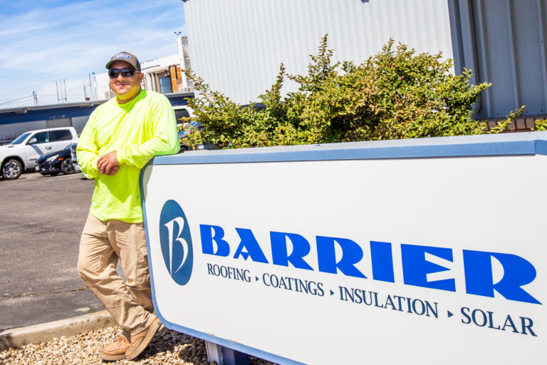 Jacob standing in front of a employer sign that says "Barrier"