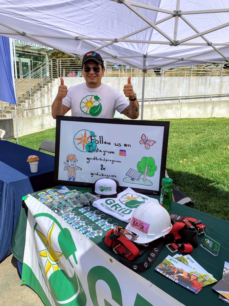 Jose Valverde, Bay Area-North Coast Community Engagement trainee is posing holding his two thumbs up for a picture at a community event in Willits, CA