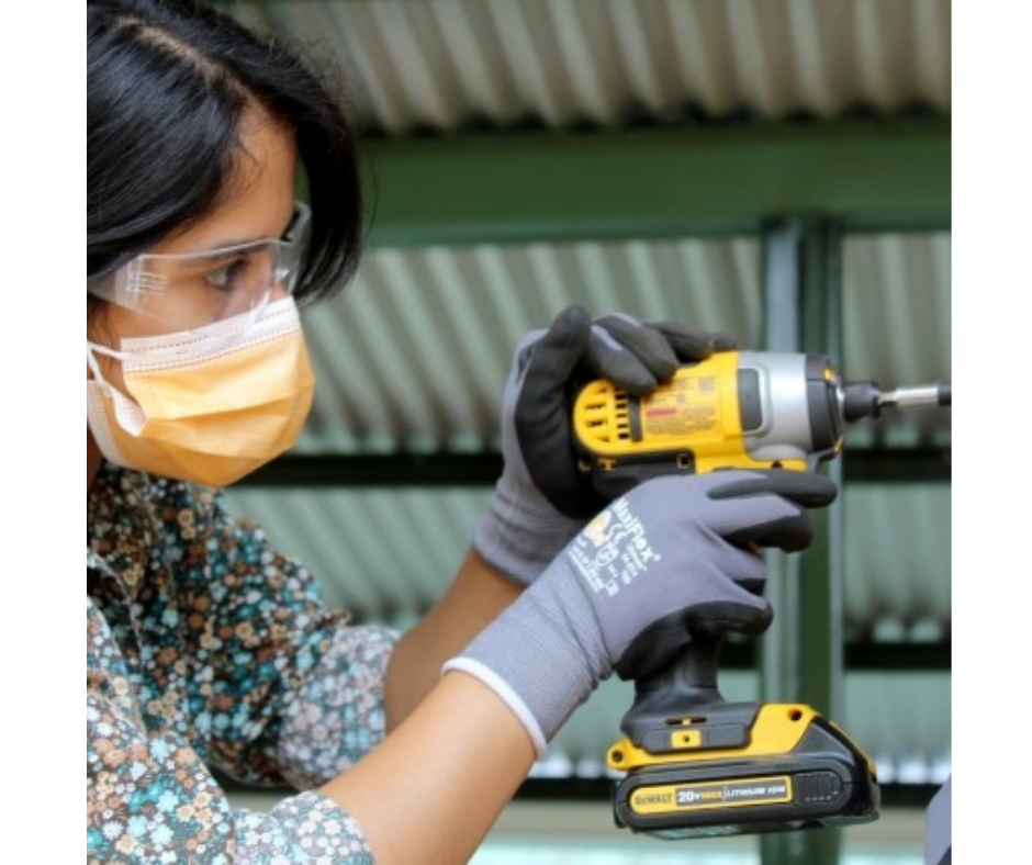 Katherine uses an impact drill.