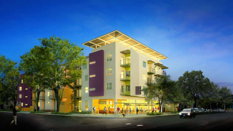 Modern multi-story residential building with colorful facade, ground-floor retail, and solar panel roof overhang at dusk
