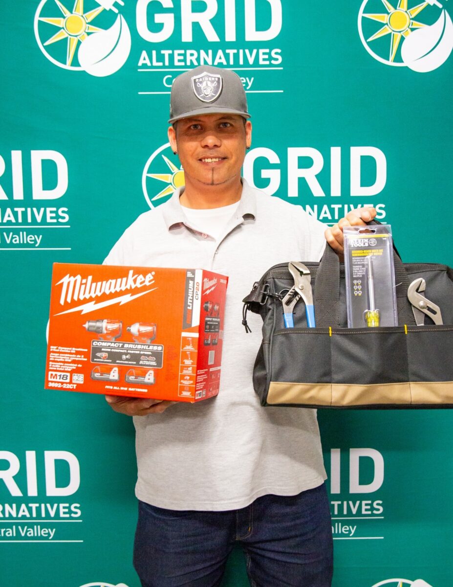Man holding tool bag for a photo