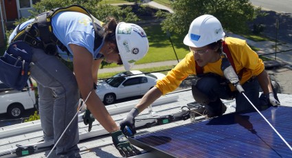 Ayaz and Nadine, a Junior Solar Installation Supervisor, install a solar module