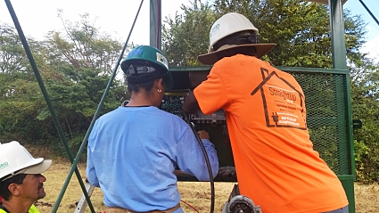 Bob's coworker Marquis, both employees at StraightUp Solar, wires the system.