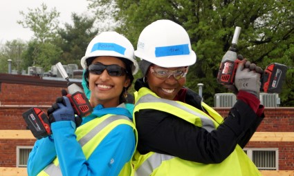Two HAND volunteers pose with impact drills