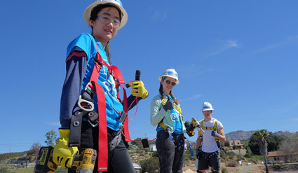 Solar Spring Break participants pose on the roof during their solar installation.