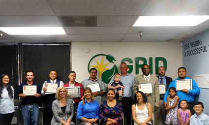 Group of people holding certificates at GRID solar construction cohort graduation ceremony