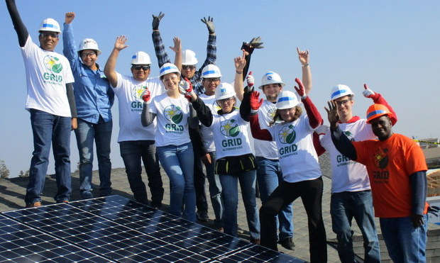 Volunteers on roof after finishing an install