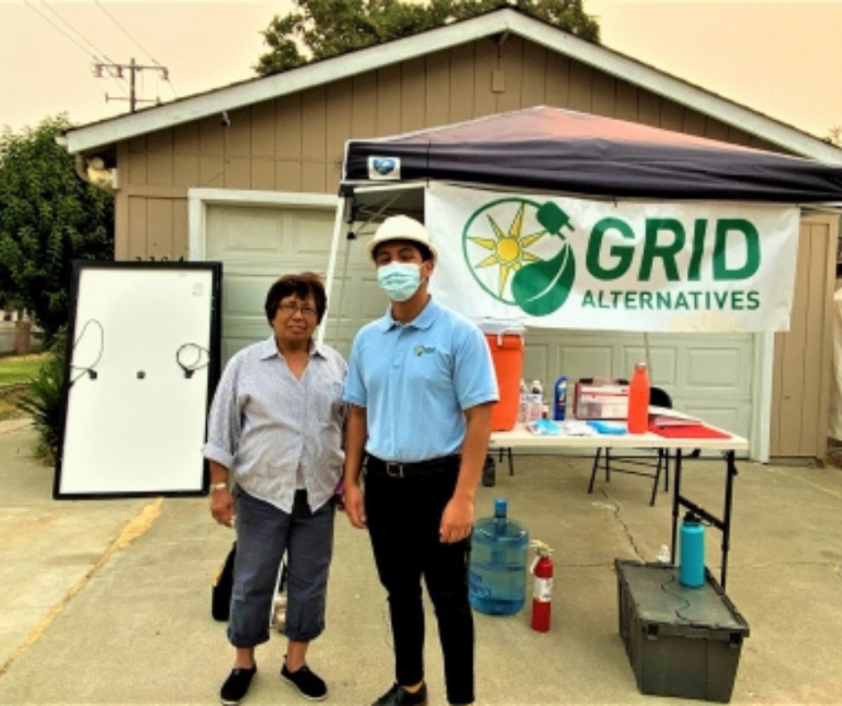 Ms. Gallegos and GRID staff in front of her home