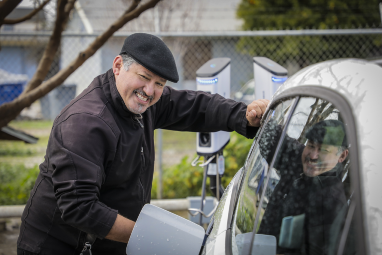 Rey Leon charging his EV at an UpliftCA event, photo by Scott Hoag