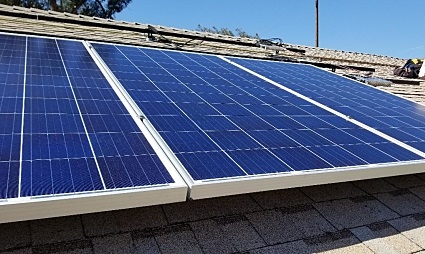 Solar panels installed on a residential rooftop under clear blue sky