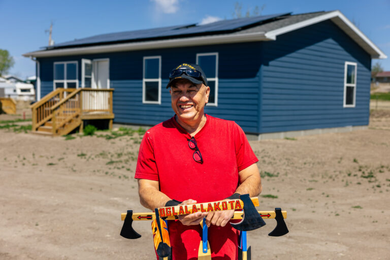 Oglala Lakota man in front of home who received solar