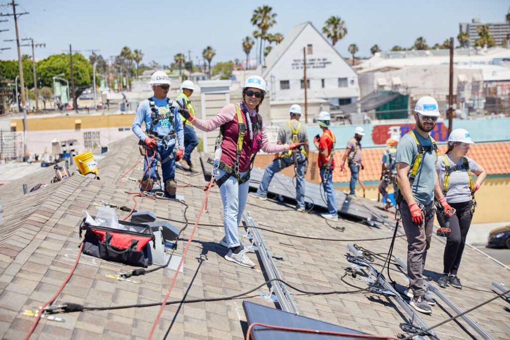 GRID GLA and volunteers installing solar panels in Long Beach