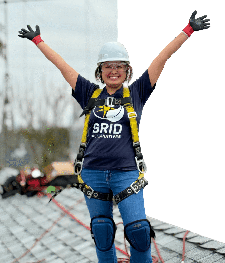 Masked image of person on roof with their arms in the air happy
