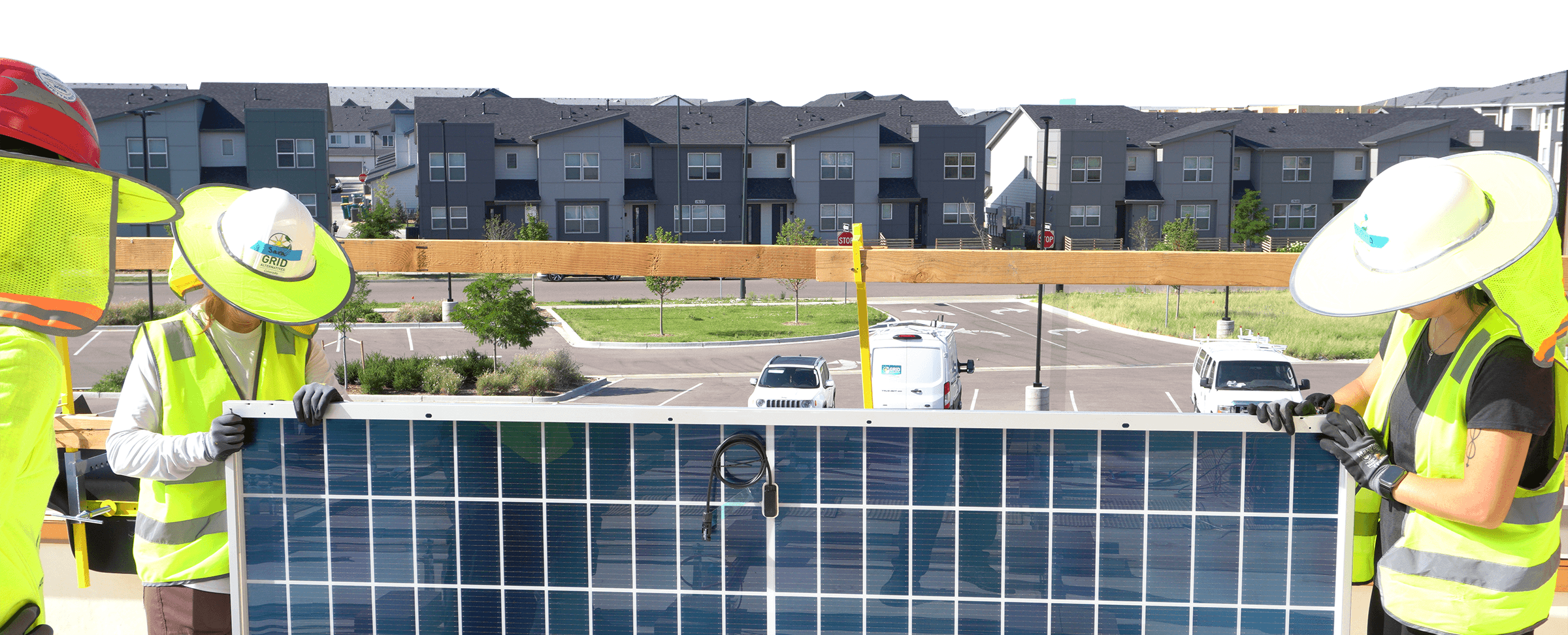 People installing solar panel with houses and condos in the background